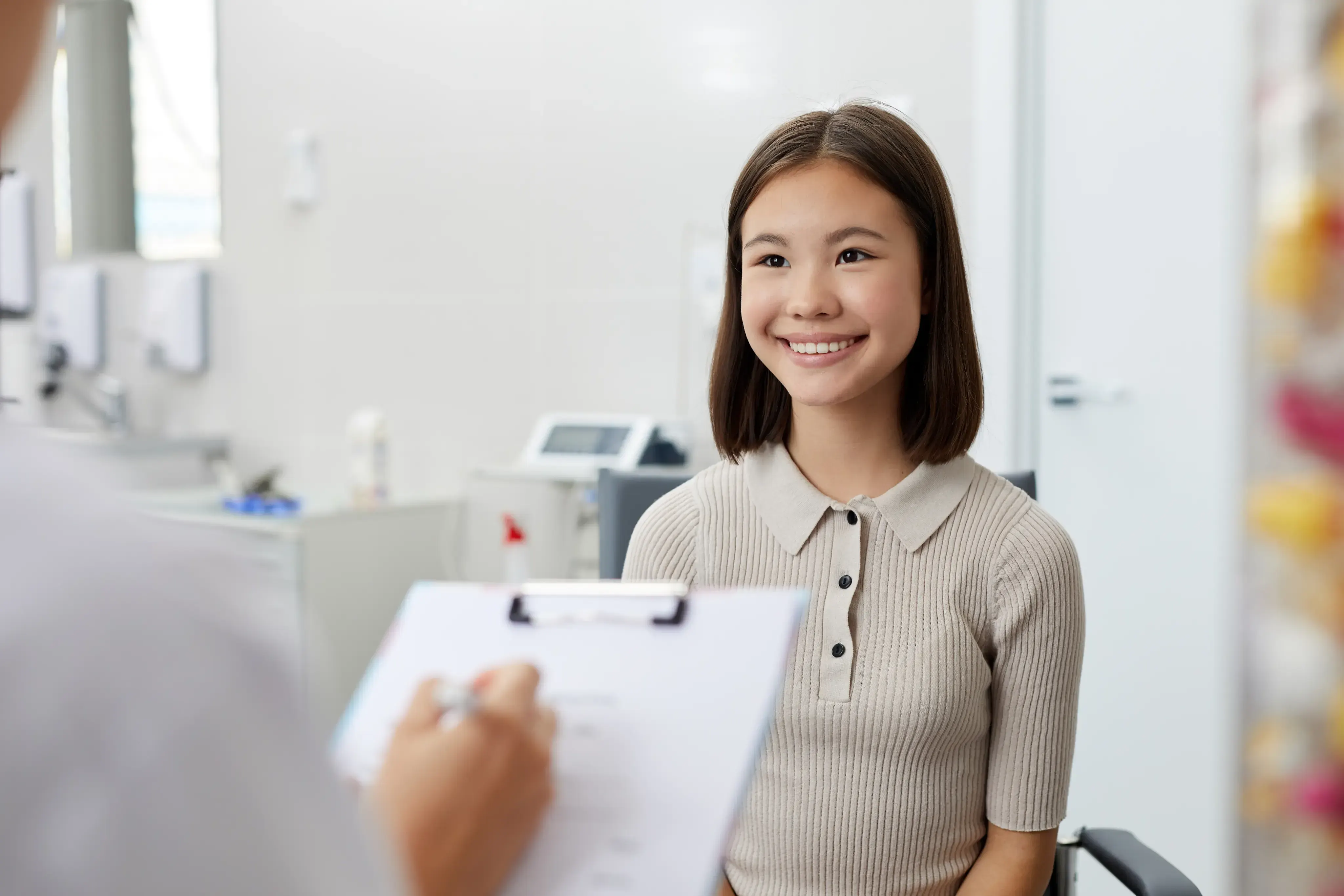 A psychiatrist in a calm clinical office reviewing notes with a patient at Gonzales-Vigilar Psychiatric Services in Ashburn, VA