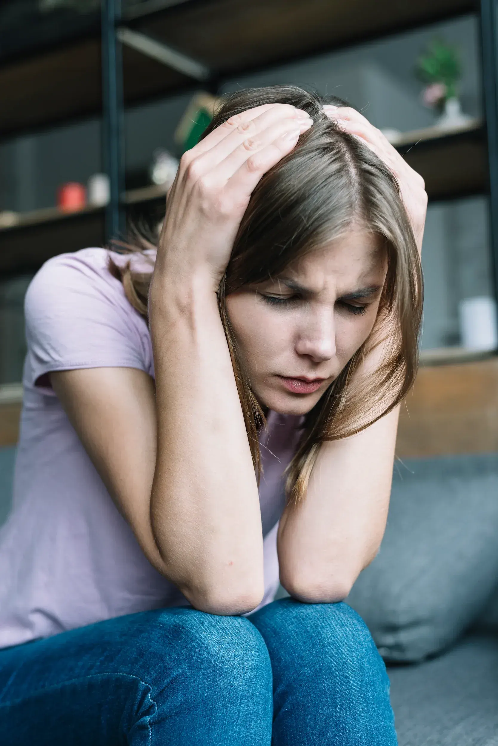 Person reflecting on depression symptoms before reaching out to Gonzales-Vigilar Psychiatric Services