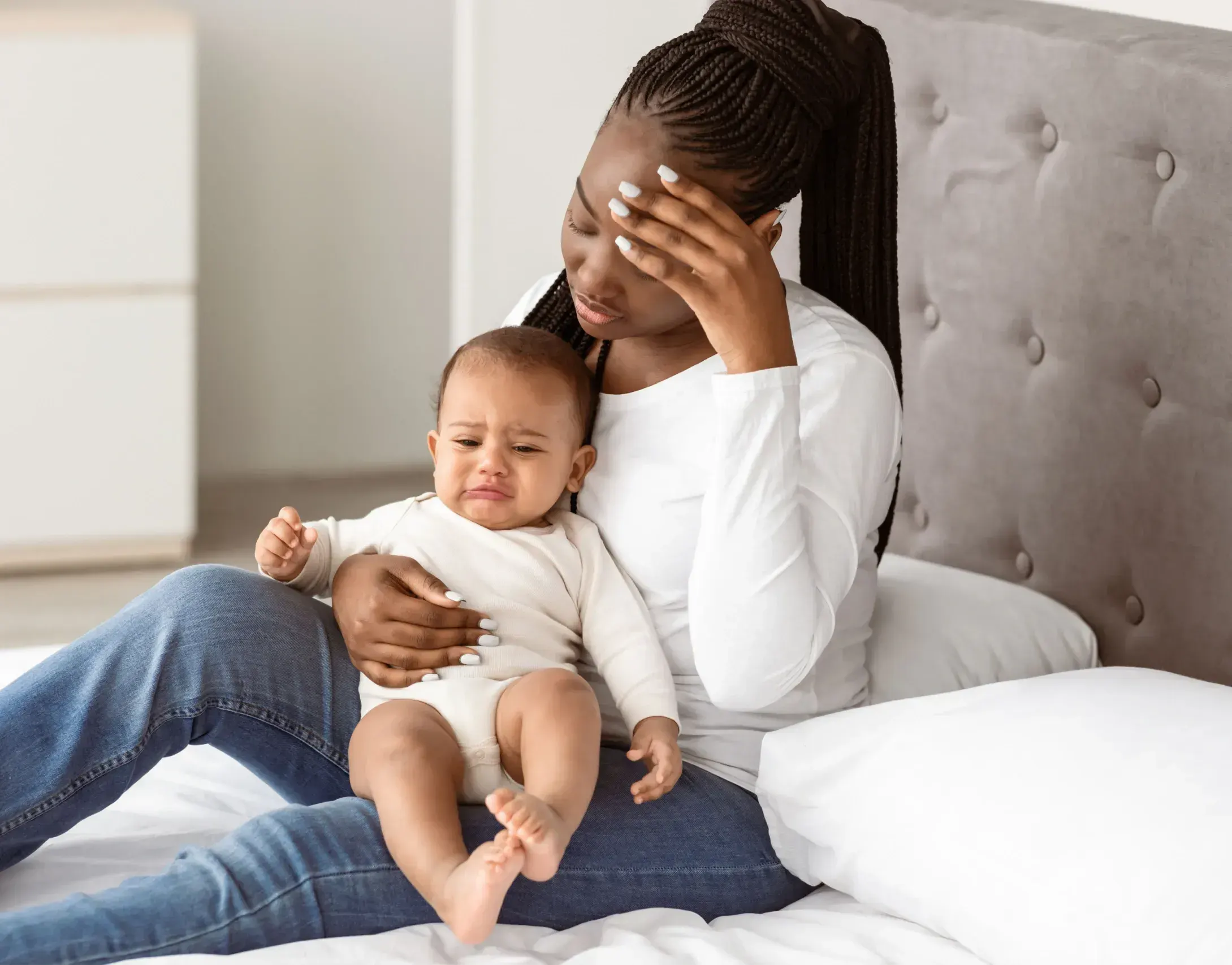 New mother gently holding her baby while speaking with her psychiatrist about postpartum depression in Ashburn, VA